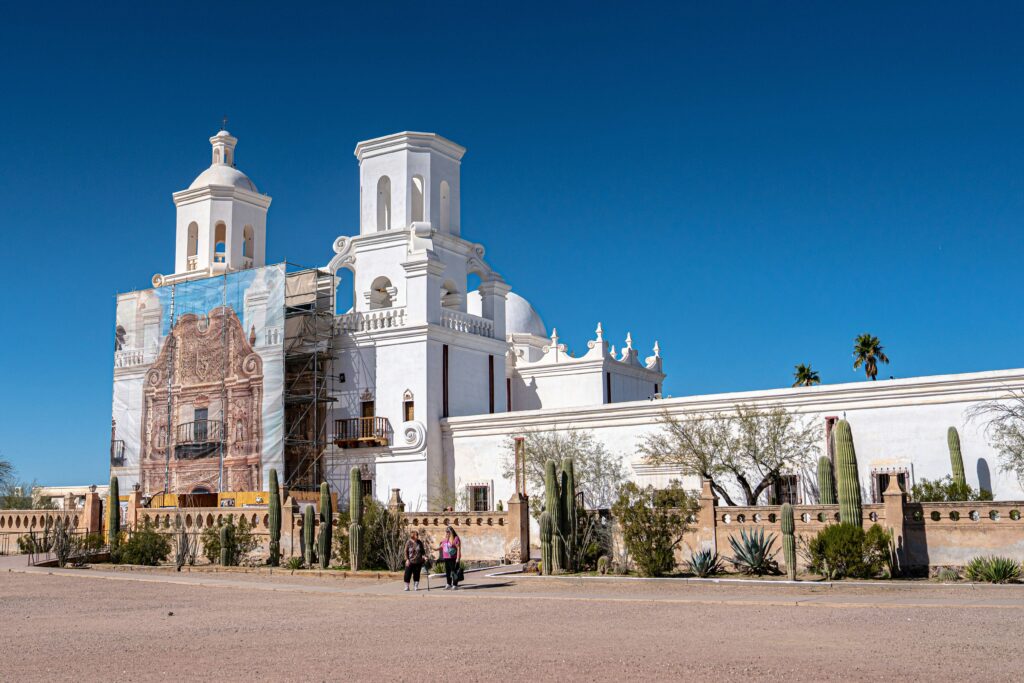 Mission San Xavier del Bac's white walls against a blue sky in the Tuscon desert