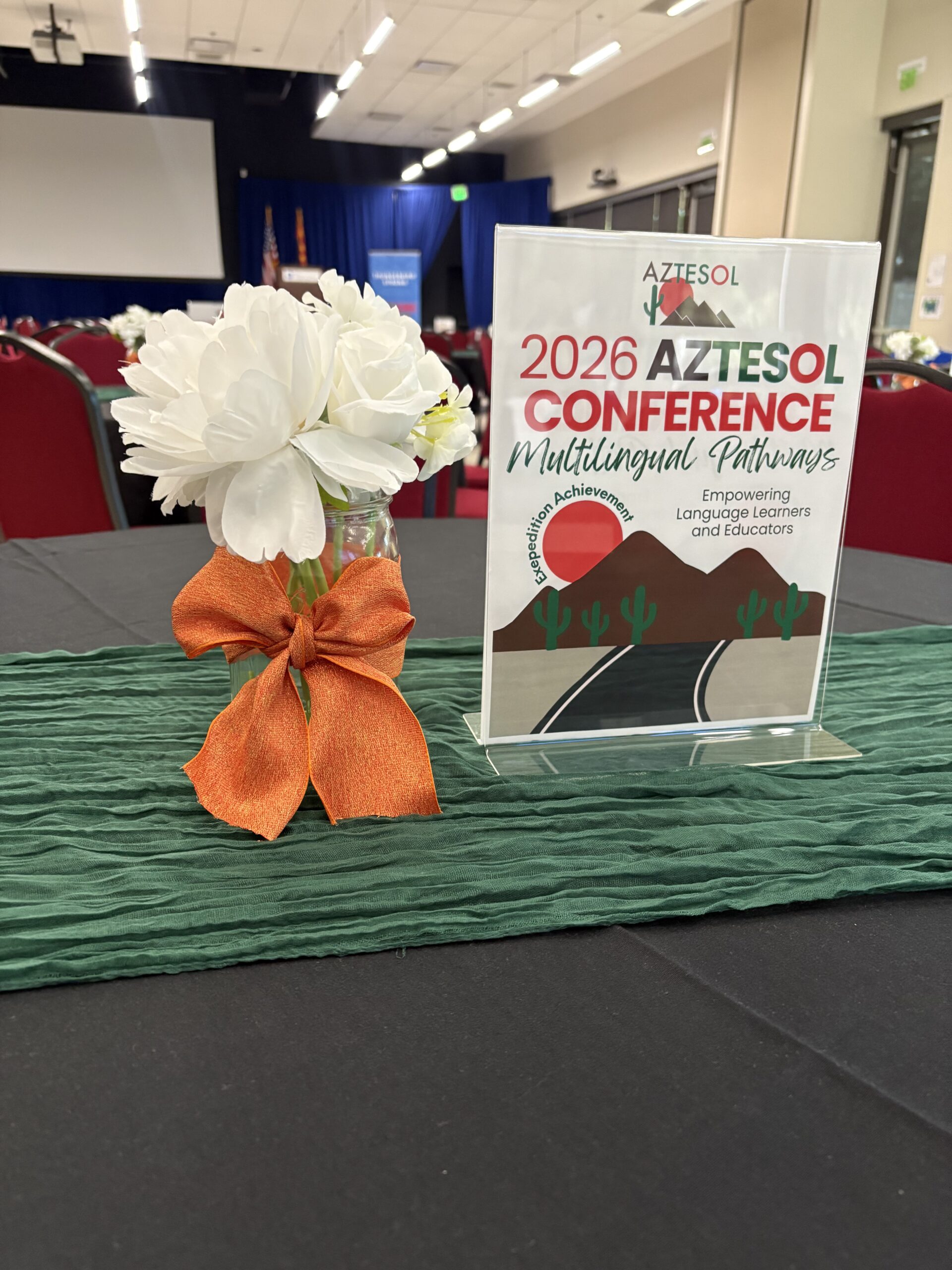 Table sign AZTESOL conference and flowers