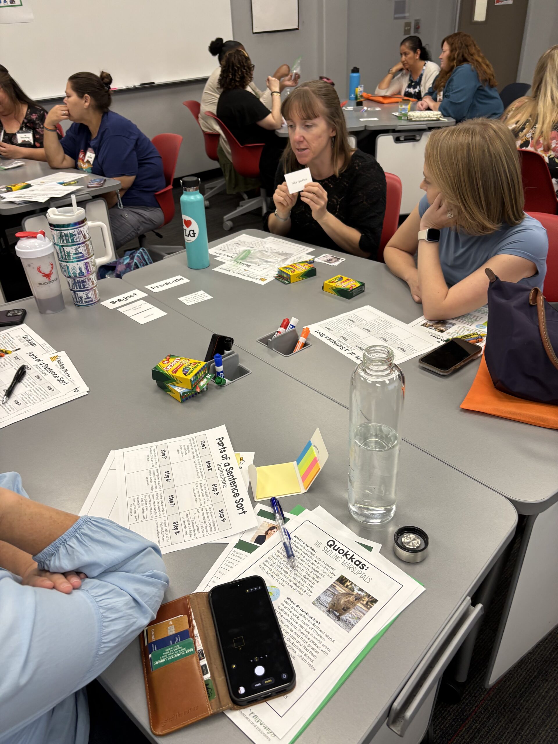 Small of people at table talking and looking at papers