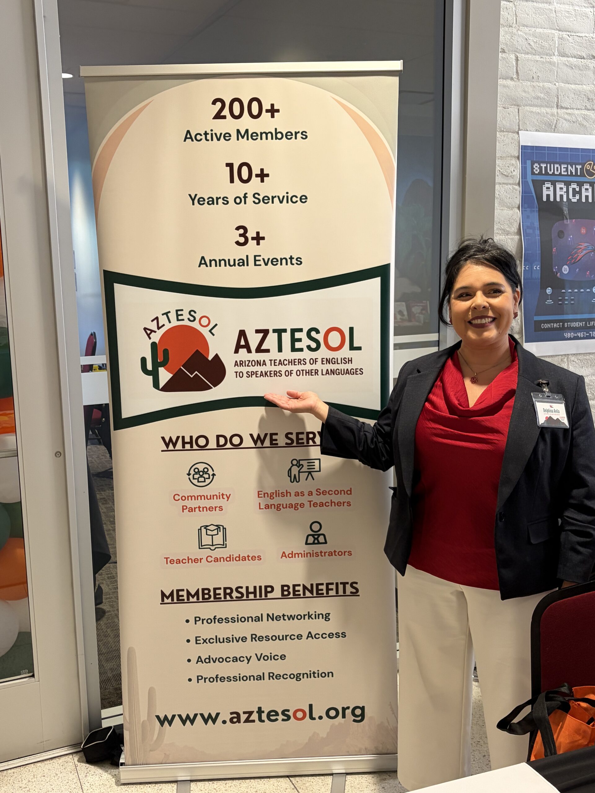 Woman sanding in front of AZTESOL poster