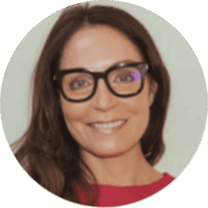 Smiling woman wearing glasses in a circular frame.