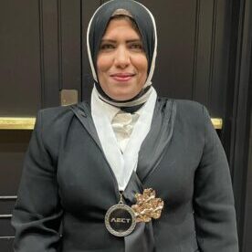 Woman wearing hijab with AECT medal.